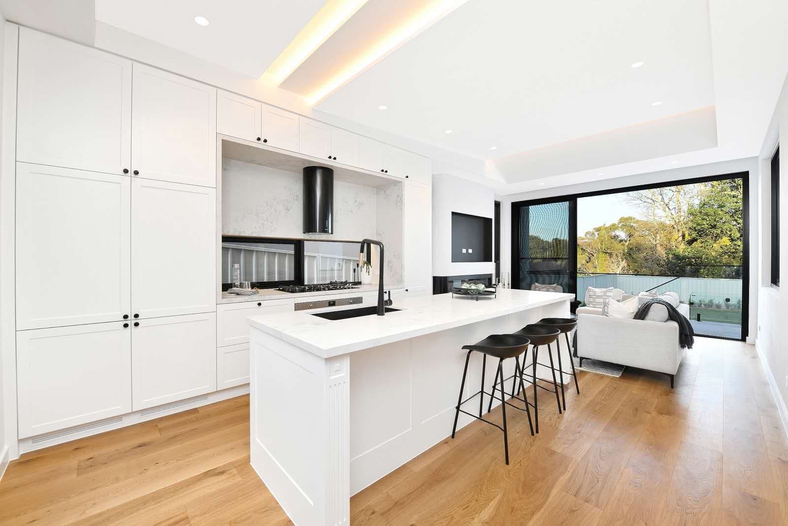 Kitchen with white cabinetry and island bench